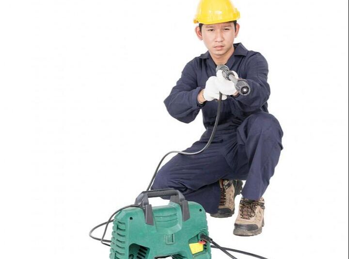 man holding a power pressure machine